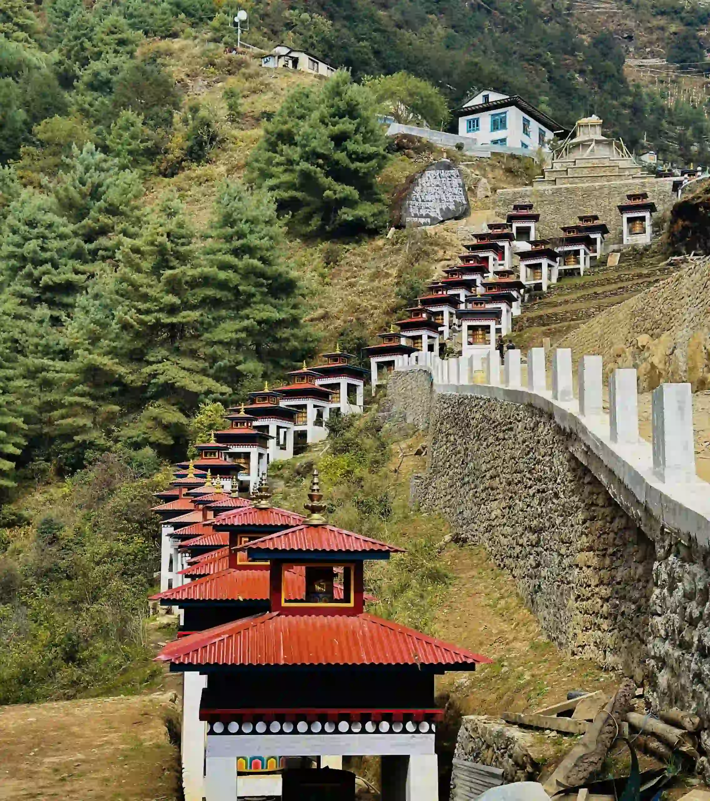 Long mani wall with carved prayer stones along the trail in the Everest region during the Lukla to Namche Trek.
