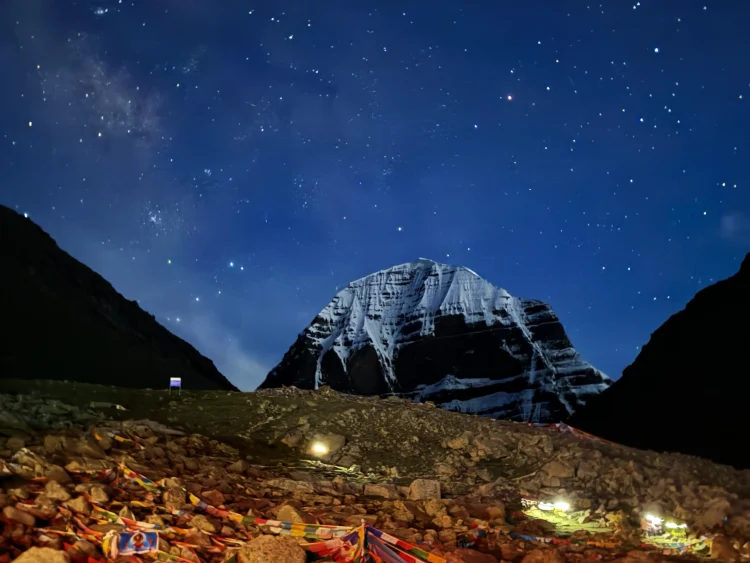 Sacred Mt Kailash north face at night under starry Milky Way sky – highlight of fixed departure Kailash Yatra 2026 from Nepal