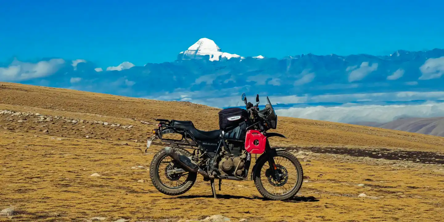 Mt. Kailash Motorbike Tour from Nepal - Royal Enfield Himalayan motorcycle with sacred Mount Kailash in the background
